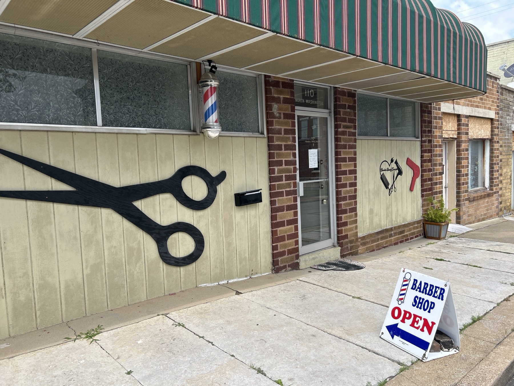 Absolute Beauty & Barber storefront on the corner in Neosho